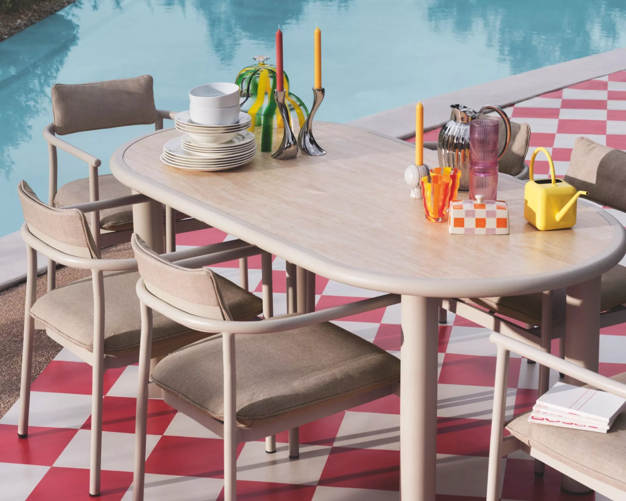 Cutlery displayed on an outdoor table and chairs, by the pool side