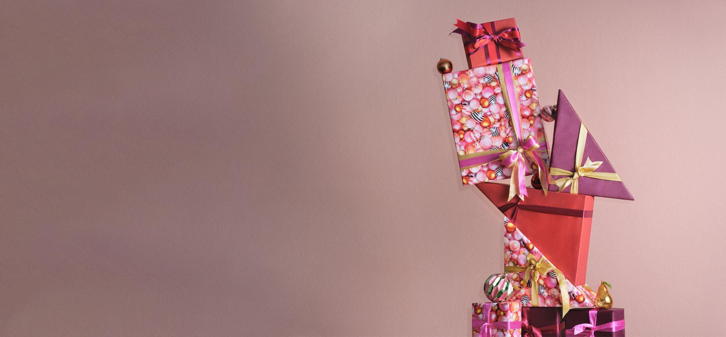 Image of a stack of presents on a pink background