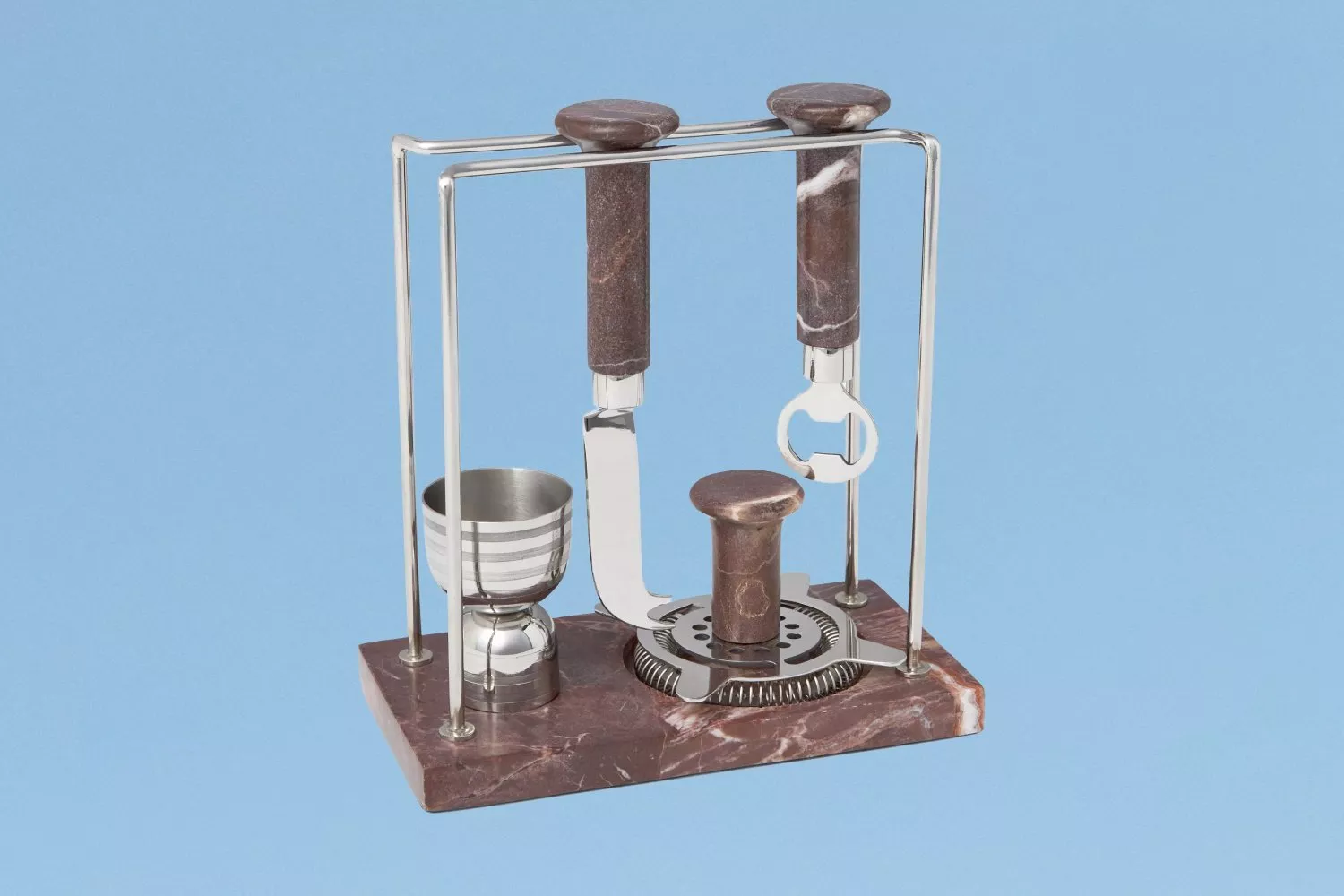 Vintage marble bar tool set with stainless steel stand, bottle opener, strainer and jigger on blue background