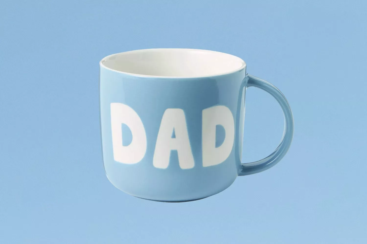 Light blue ceramic mug with bold white “DAD” lettering, ideal Father’s Day gift, on a plain blue background