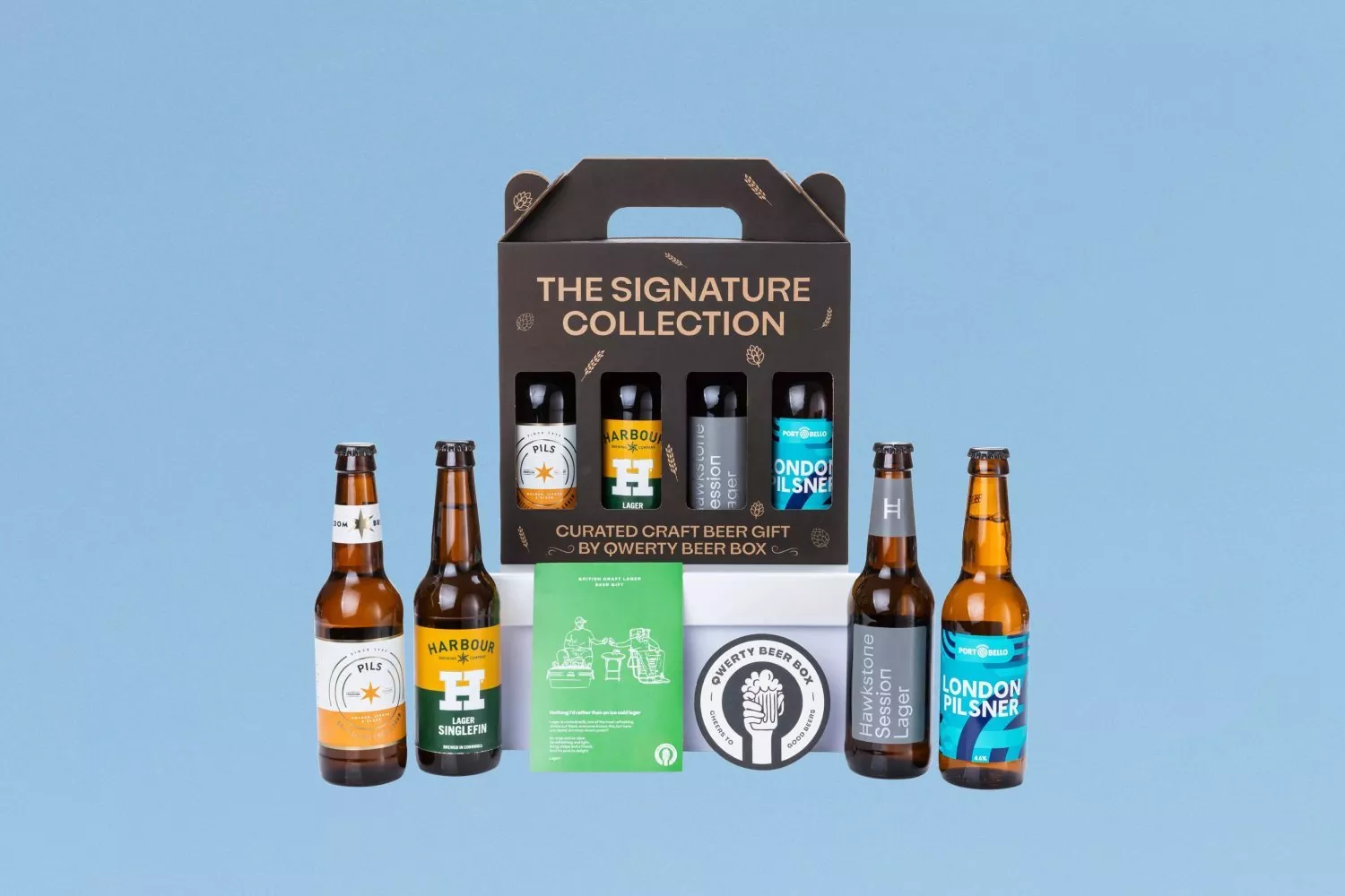 Qwerty Beer Box Signature Collection craft beer gift set with assorted bottled lagers and pilsners on blue background