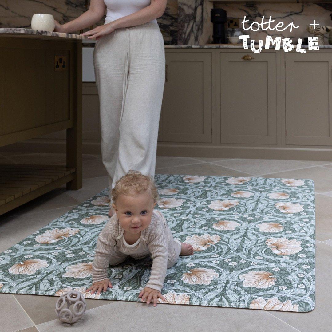 Image of a baby crawling on a stylish playmat/rug by Totter and Tumble