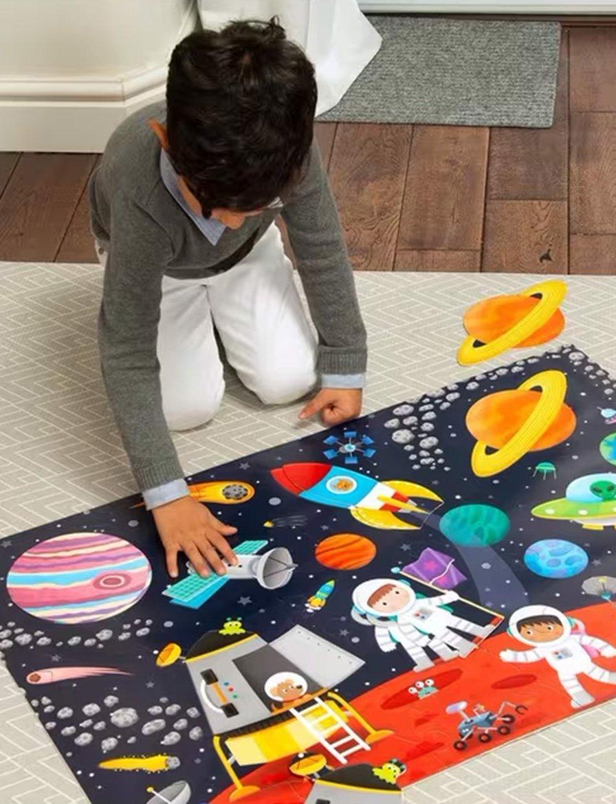 Child playing with a colorful space-themed puzzle mat