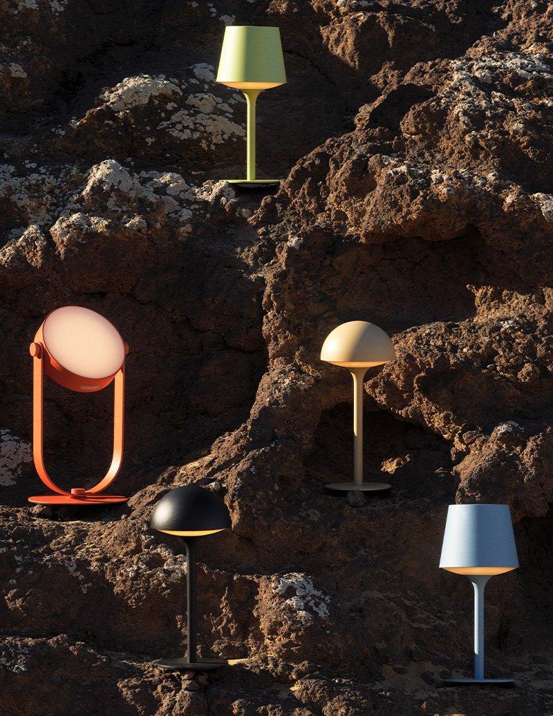 several bedside lamps perched on a rocky bay