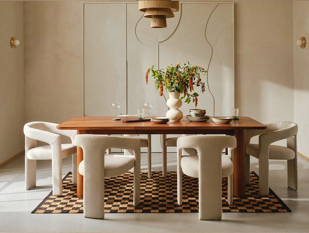 Dining room with cream coloured chairs and wooden dining table