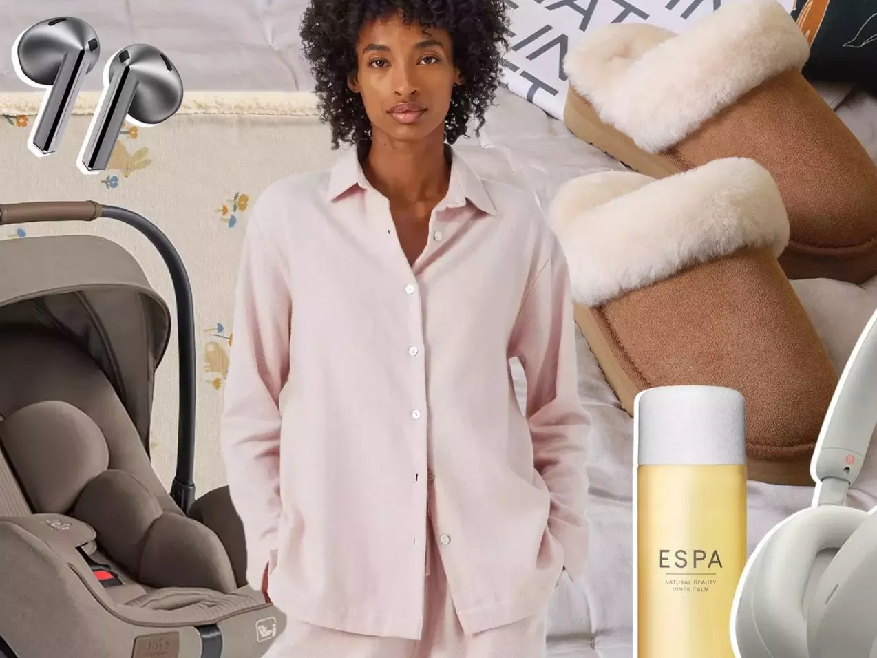 Woman in pink loungewear with cosy slippers, earbuds, baby car seat and ESPA skincare on bed backdrop