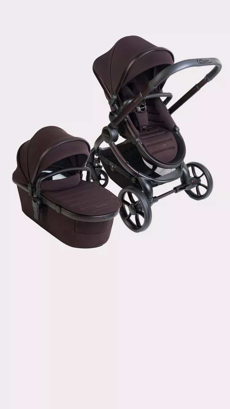 Luxury dark plum pushchair with carrycot and pram seat, four-wheel travel system on a clean studio background