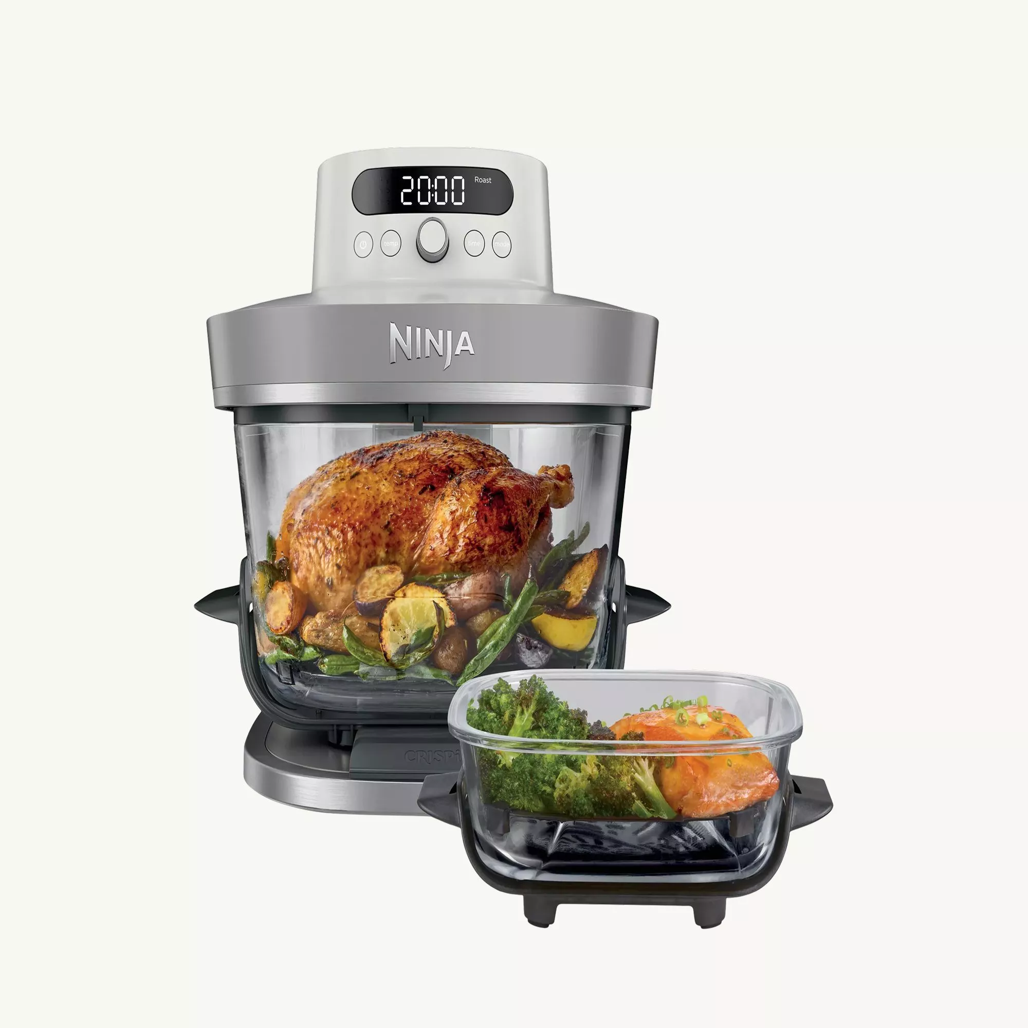 Ninja countertop air fryer oven with glass bowl roasting chicken and veg, plus extra tray with salmon and broccoli