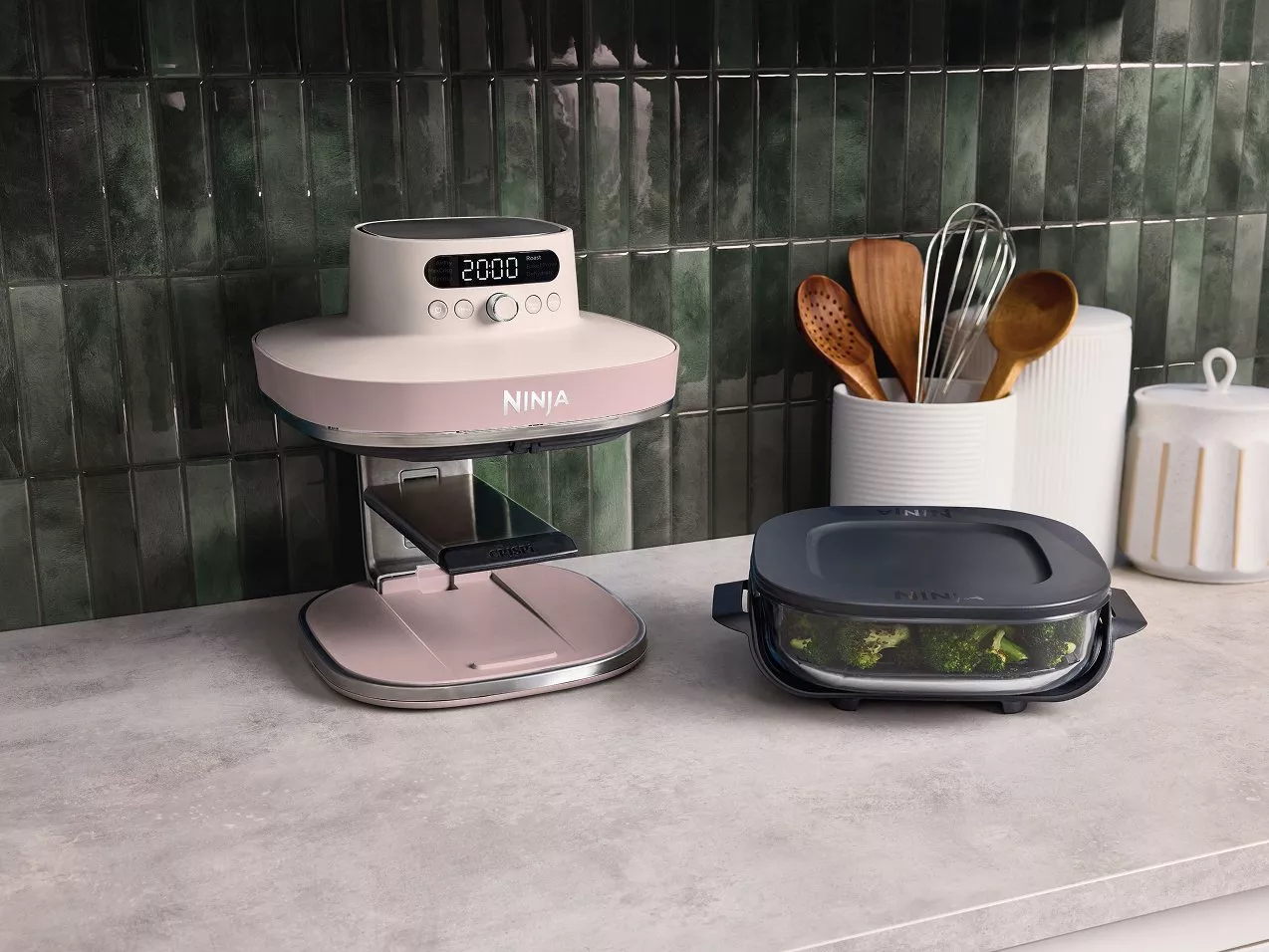Ninja air fryer with digital timer beside glass meal prep container on modern kitchen worktop