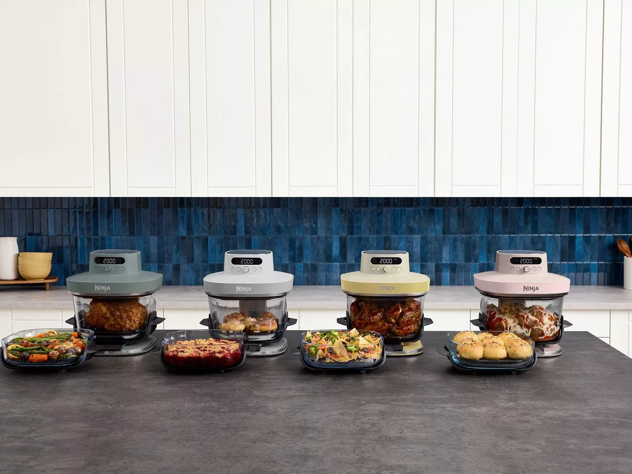 Four Ninja air fryer ovens in a modern kitchen