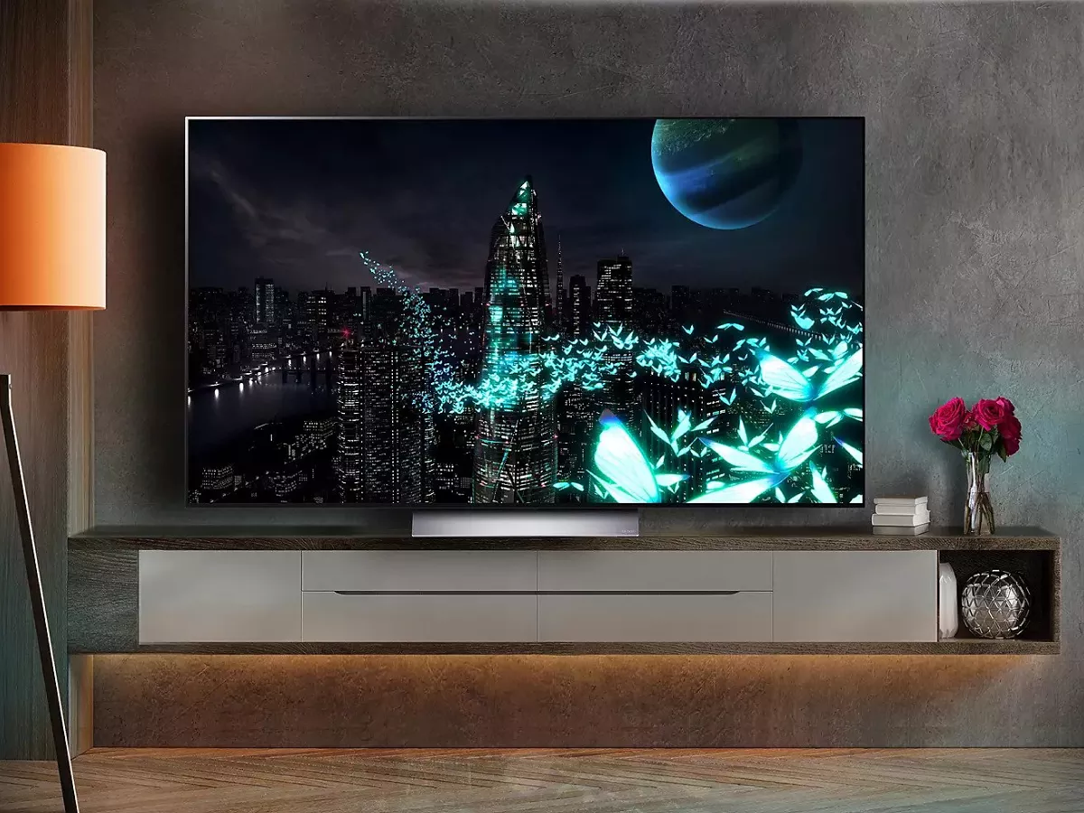 Large flat-screen TV showing futuristic night city skyline with glowing butterflies and a planet in the sky