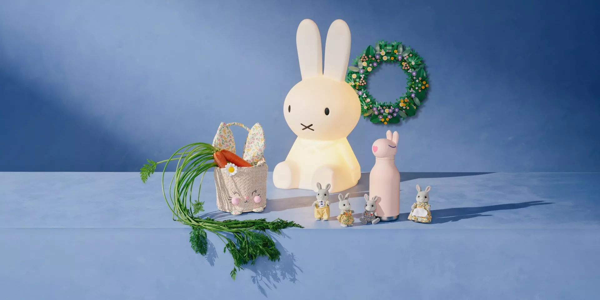 Cute rabbit-themed decorations on a blue background, featuring toys, a lamp, carrots, and a floral wreath.