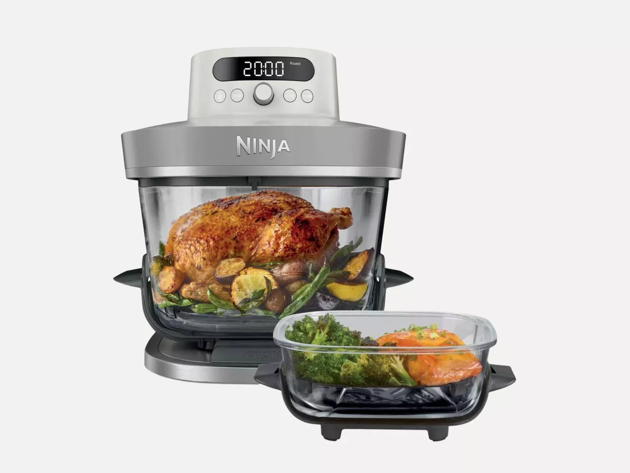 Ninja air fryer oven with digital controls, roasting whole chicken and vegetables, plus extra tray with salmon and broccoli