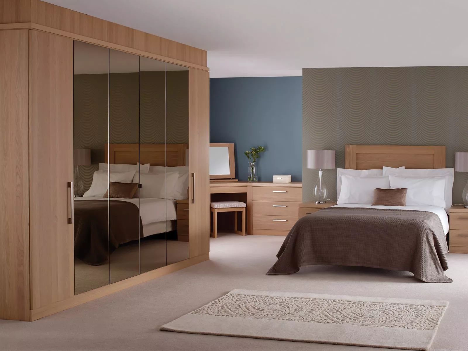 Modern bedroom with wooden furniture, mirrored wardrobe, and elegant decor. Neutral tones create a serene atmosphere.