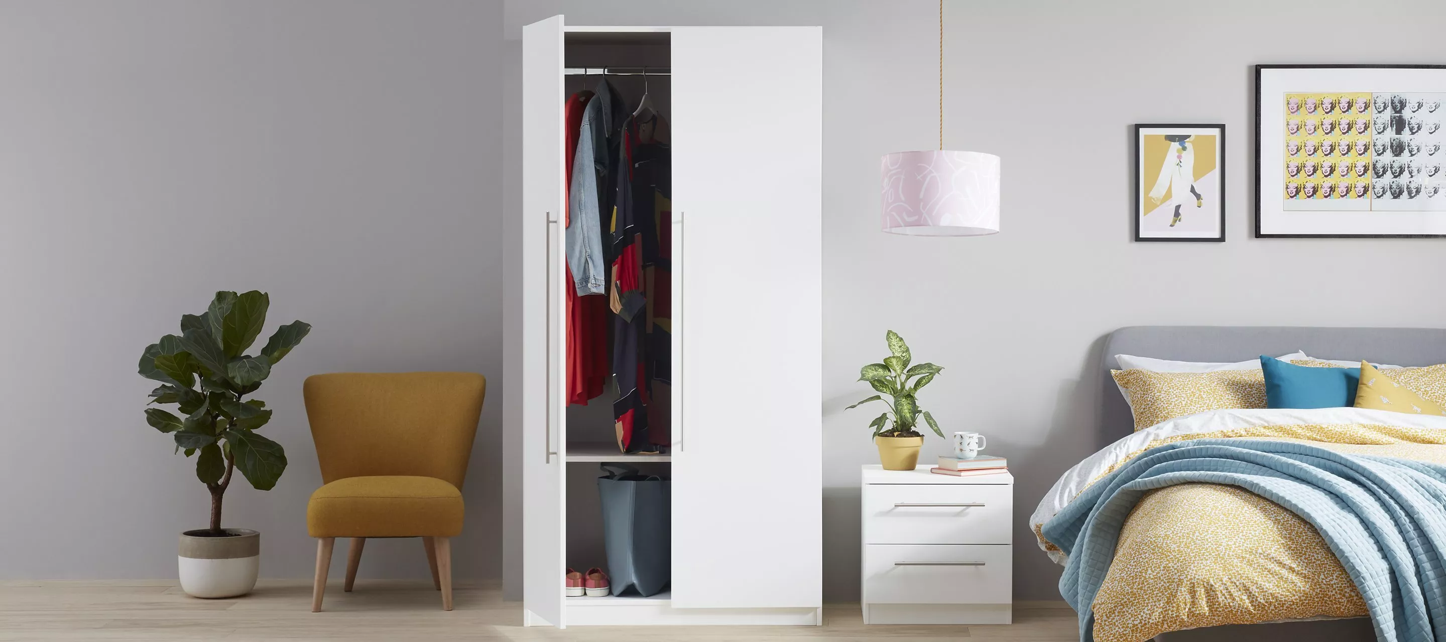 Stylish modern bedroom with white wardrobe, colourful bedding, indoor plants, and decorative wall art.