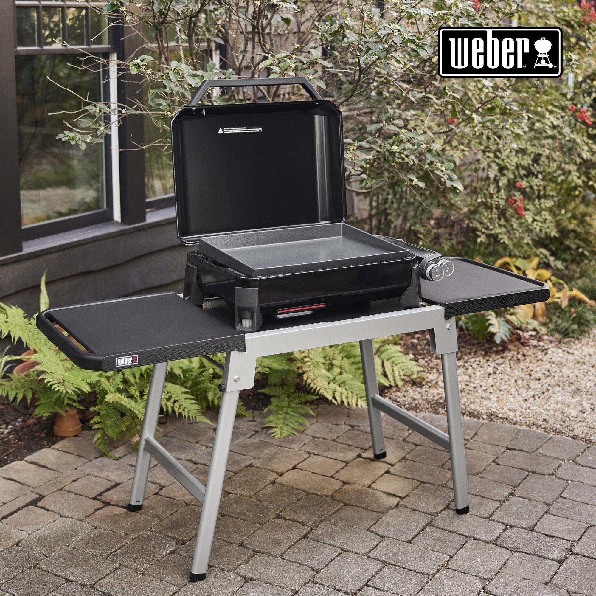 a weber outdoor electric grill setup in a backyard or garden setting