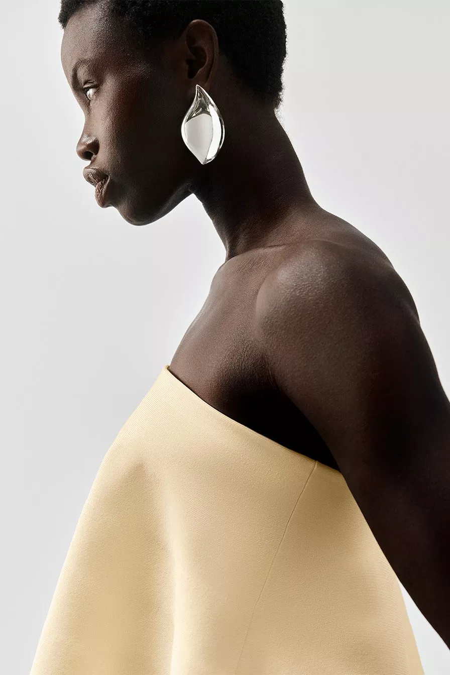 women wearing silver statement earrings