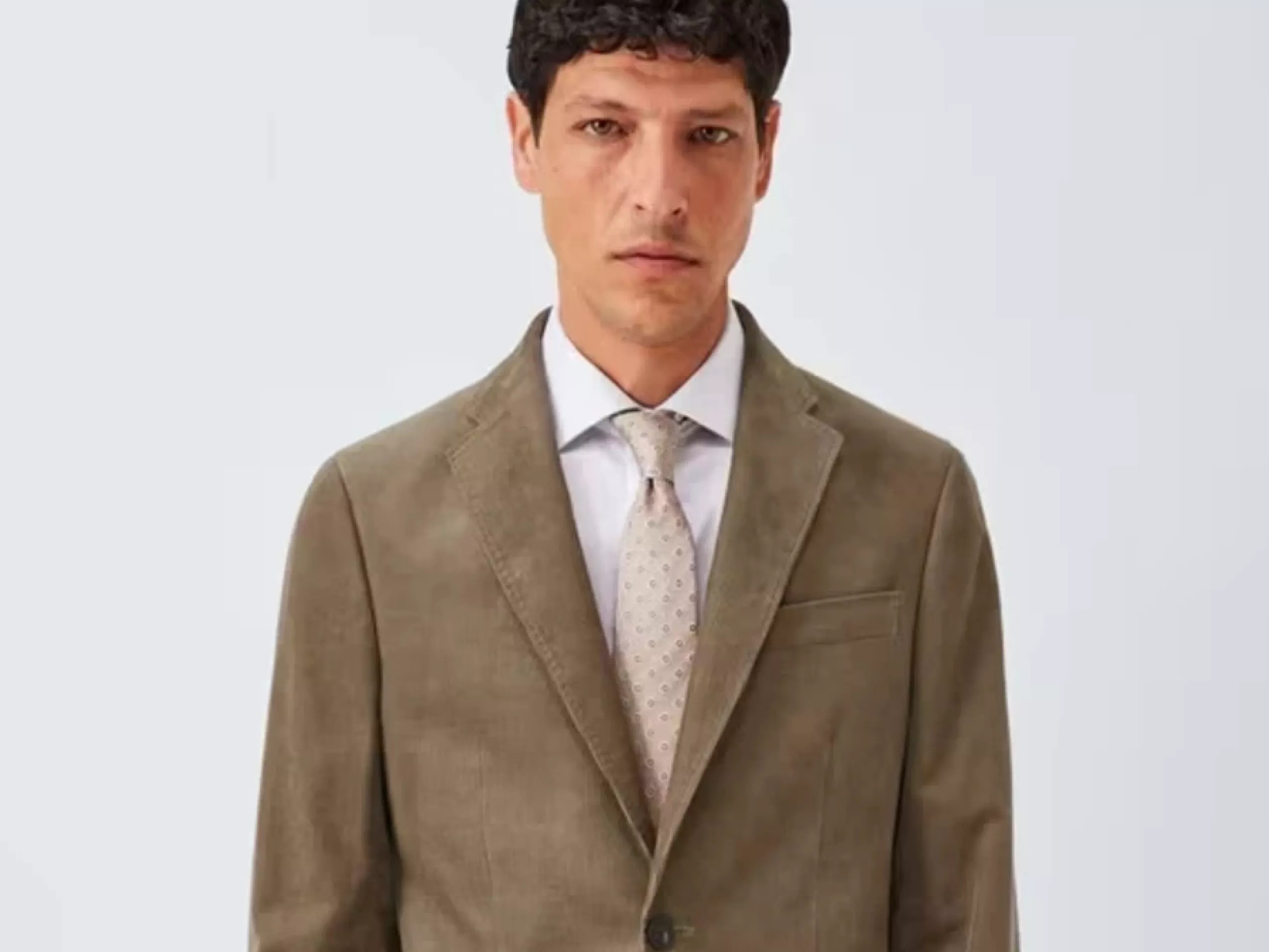 Image of a model wearing a tan suit jacket