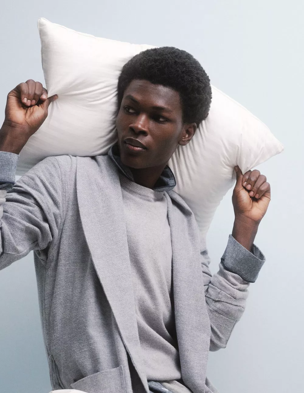 man holding pillows
