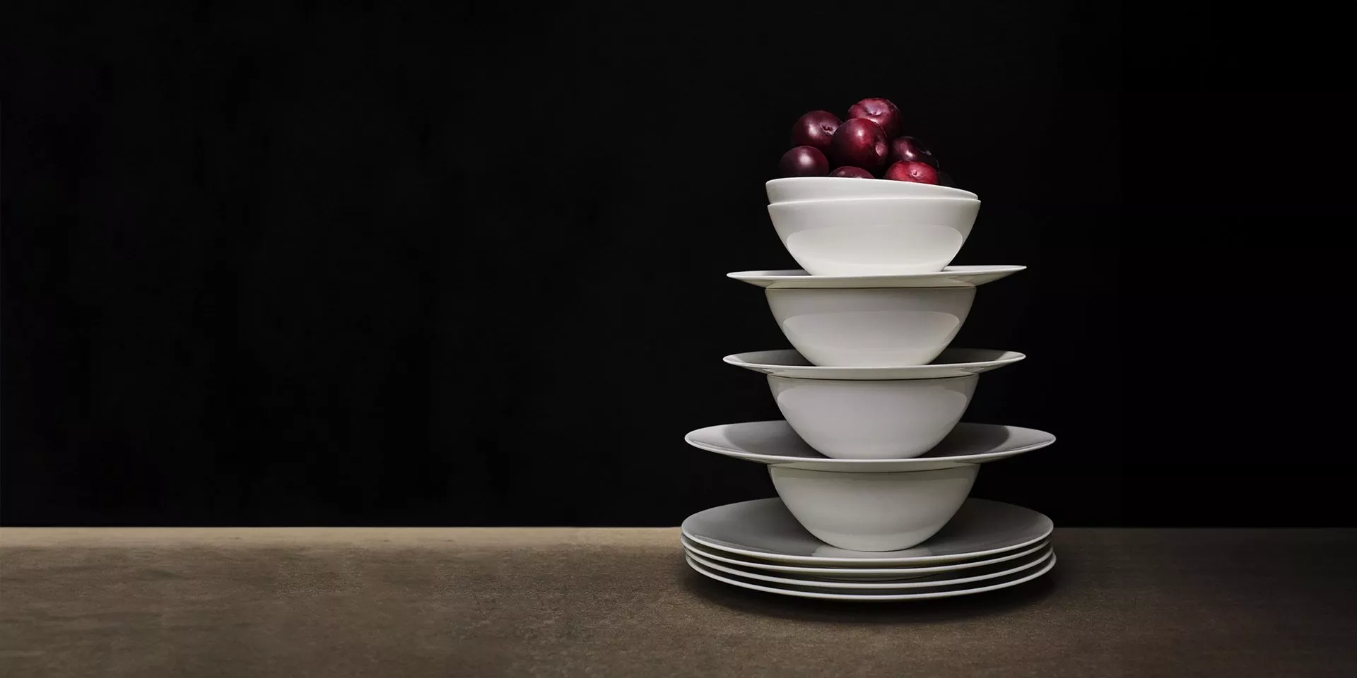 Stack of white china bowls and plates