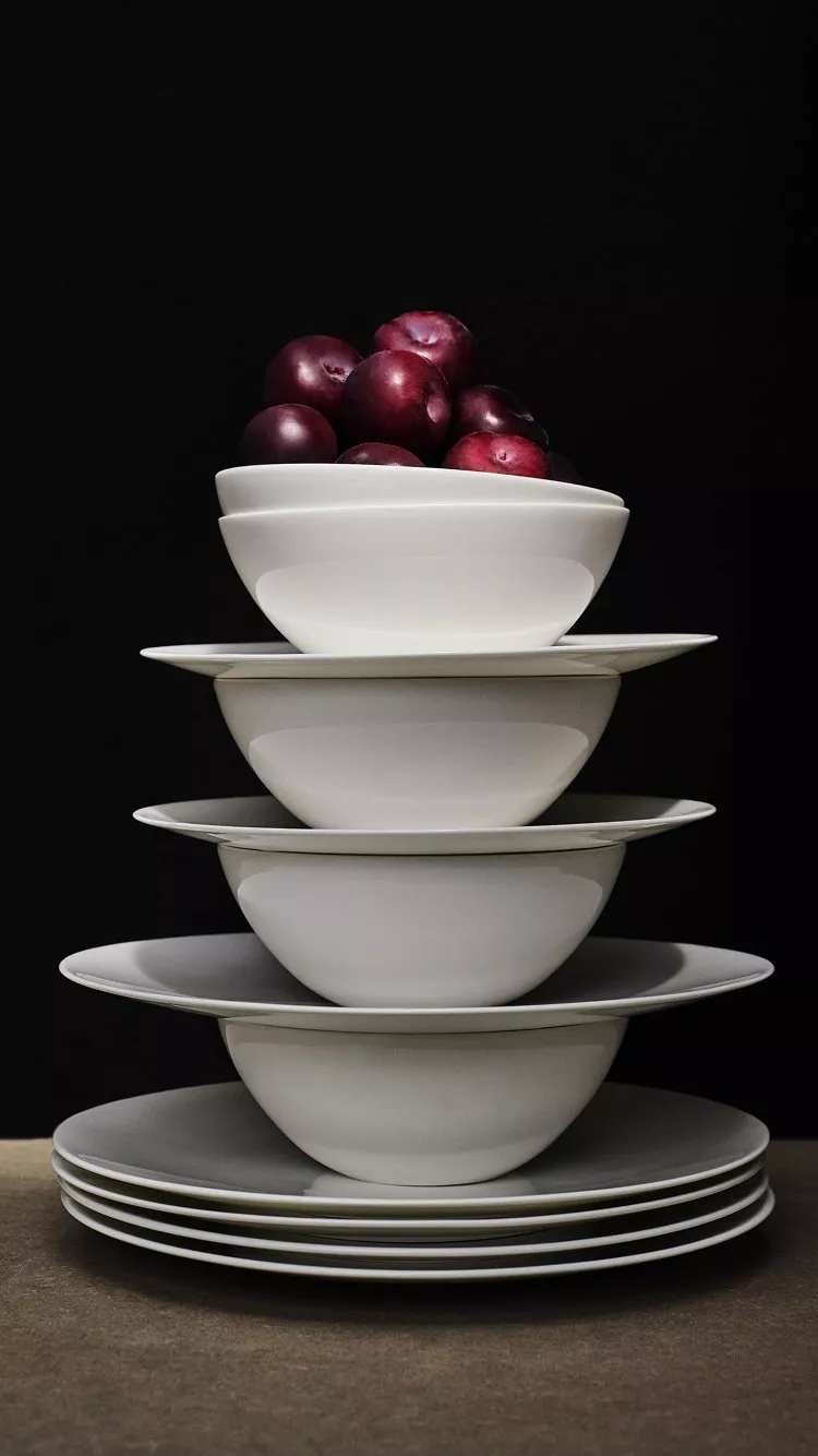 Stack of white china bowls and plates