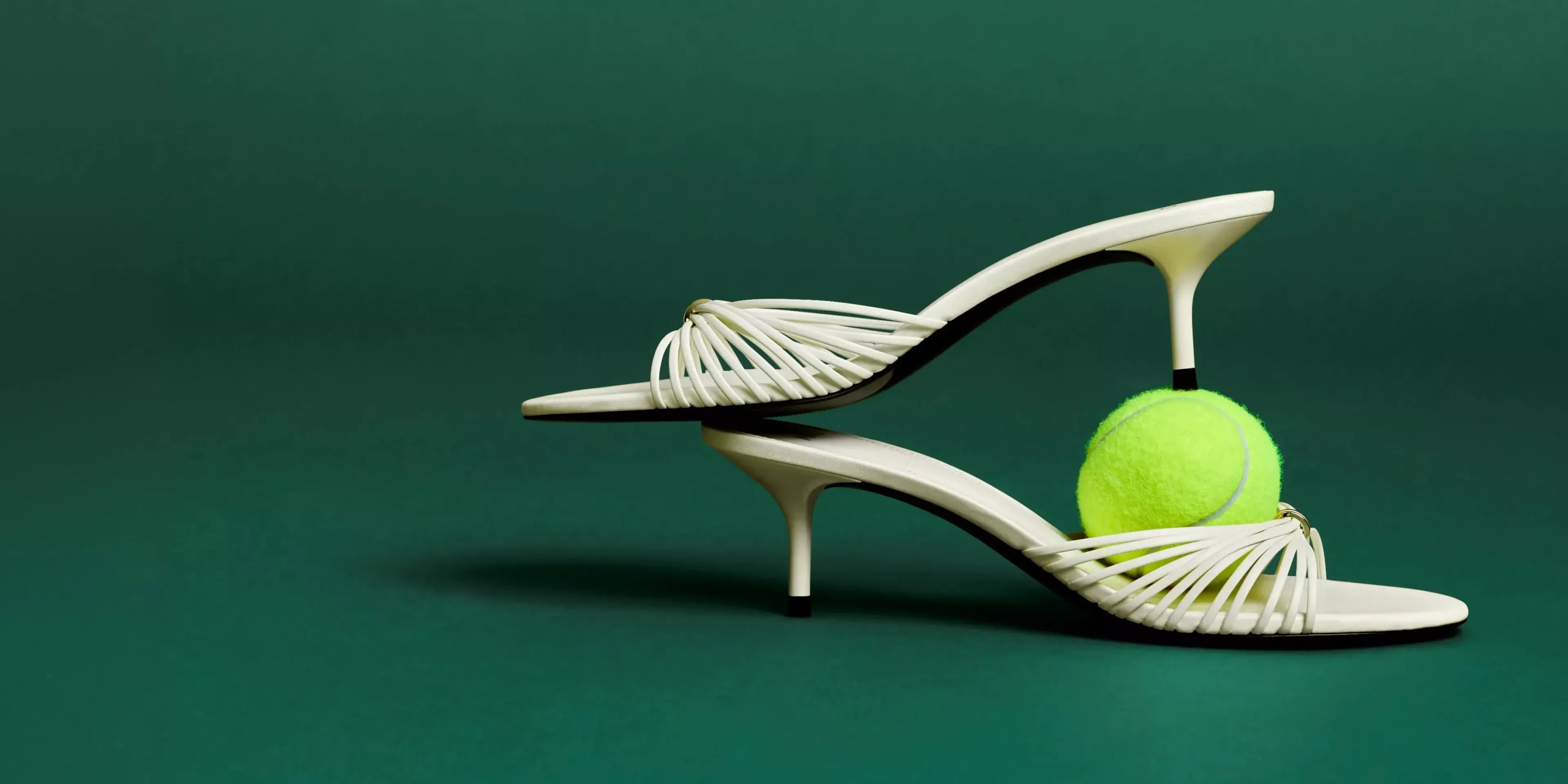 women in a dress holding a tennis racket