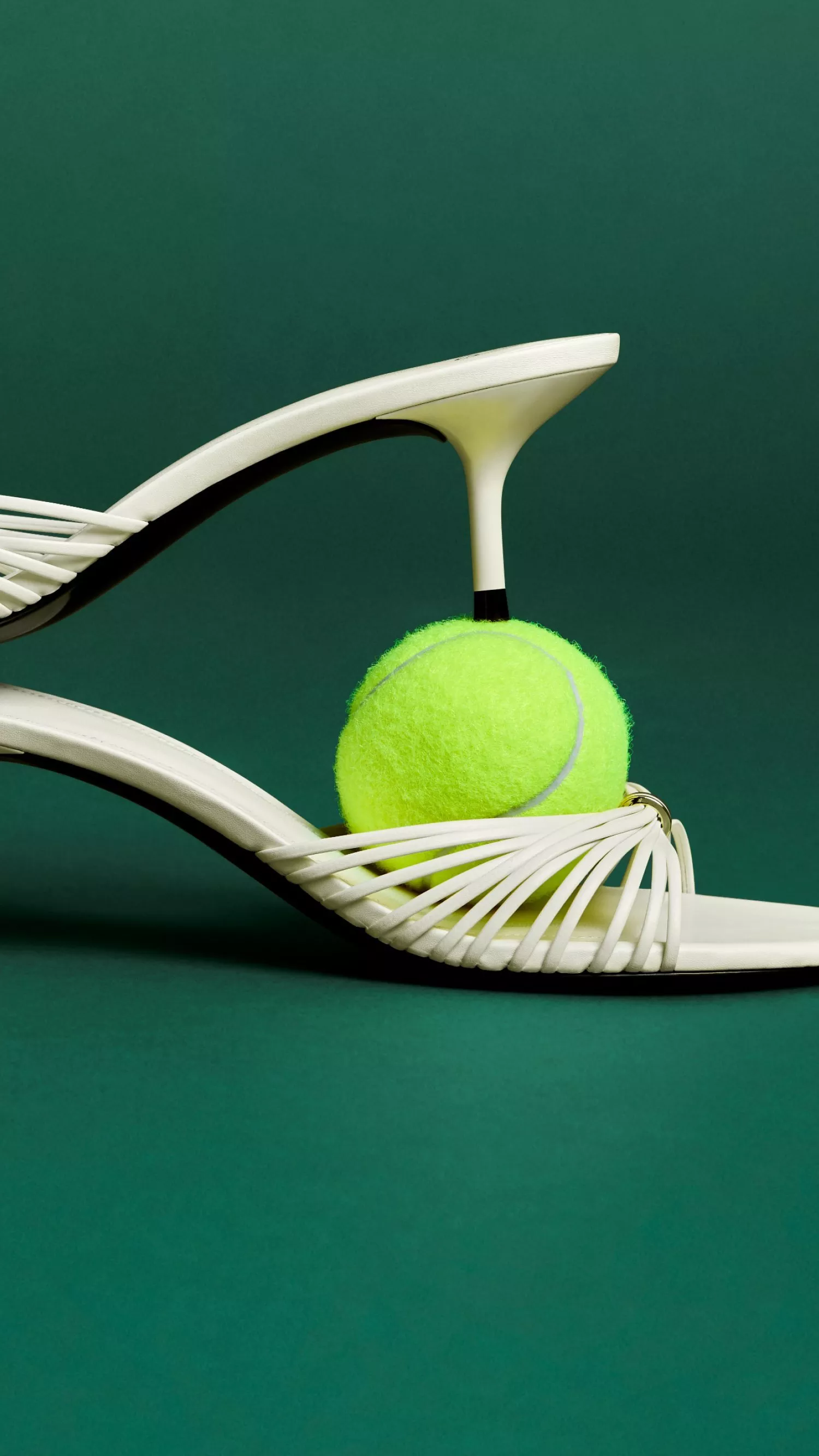 women in a dress holding a tennis racket