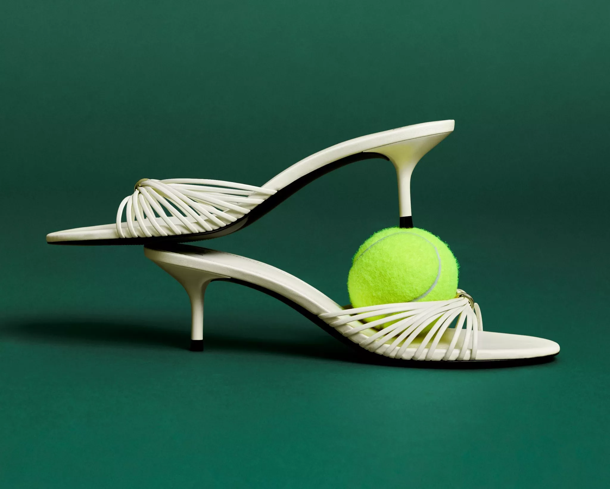 women wearing a dress holding a tennis racket