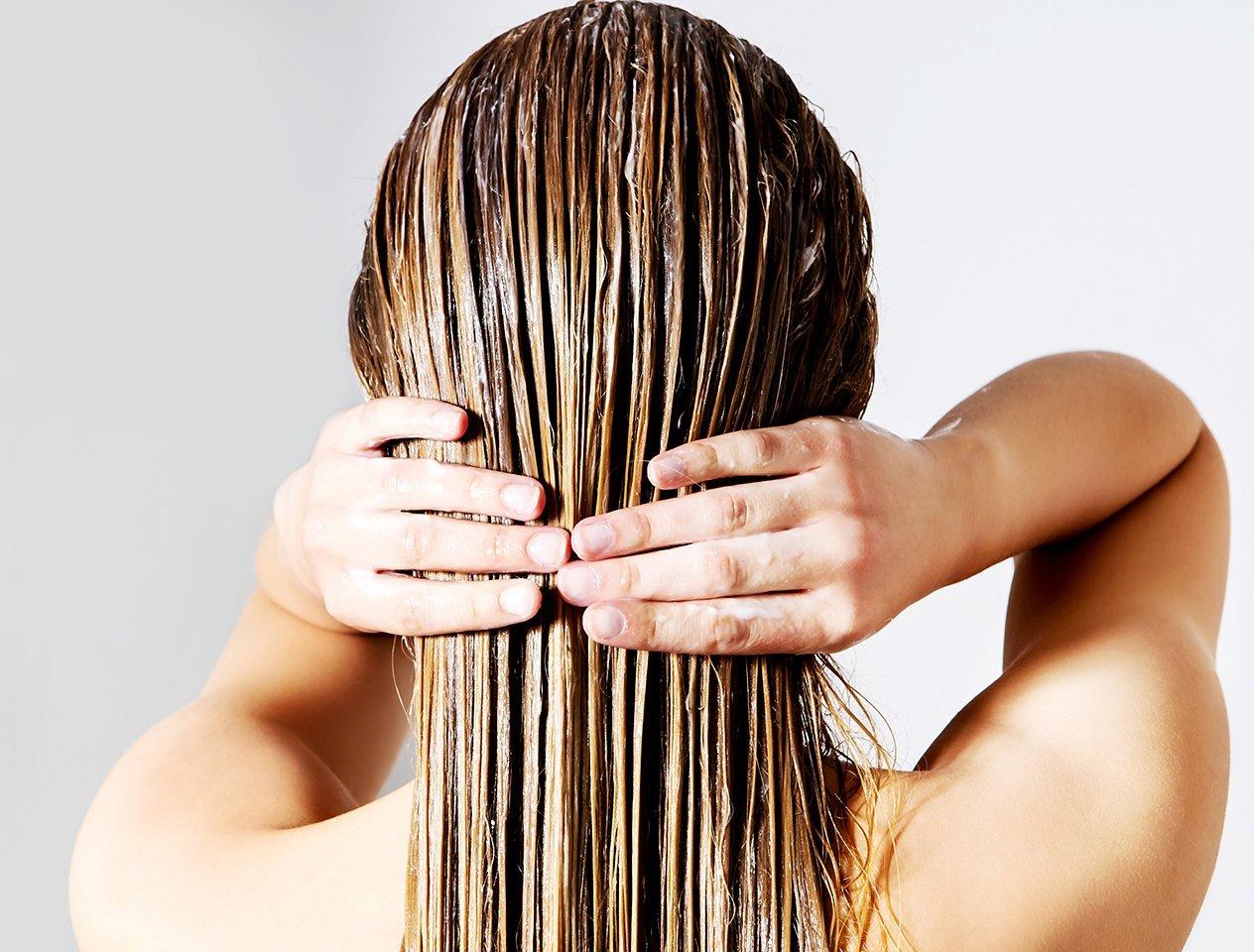 Lady applying hair conditioner