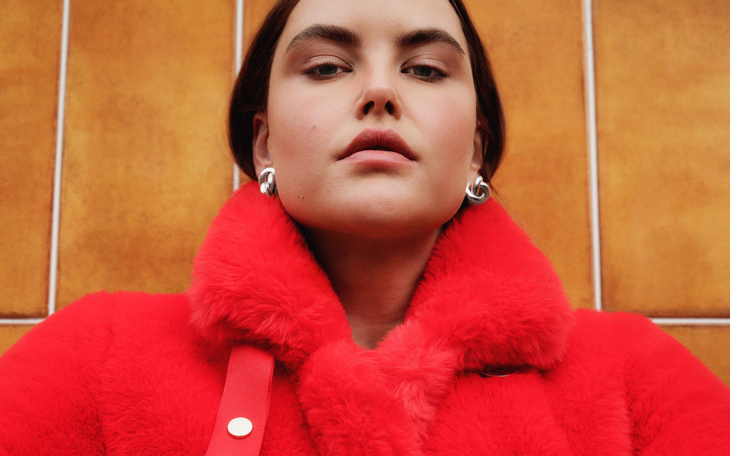 Female model wearing red fur winter coat
