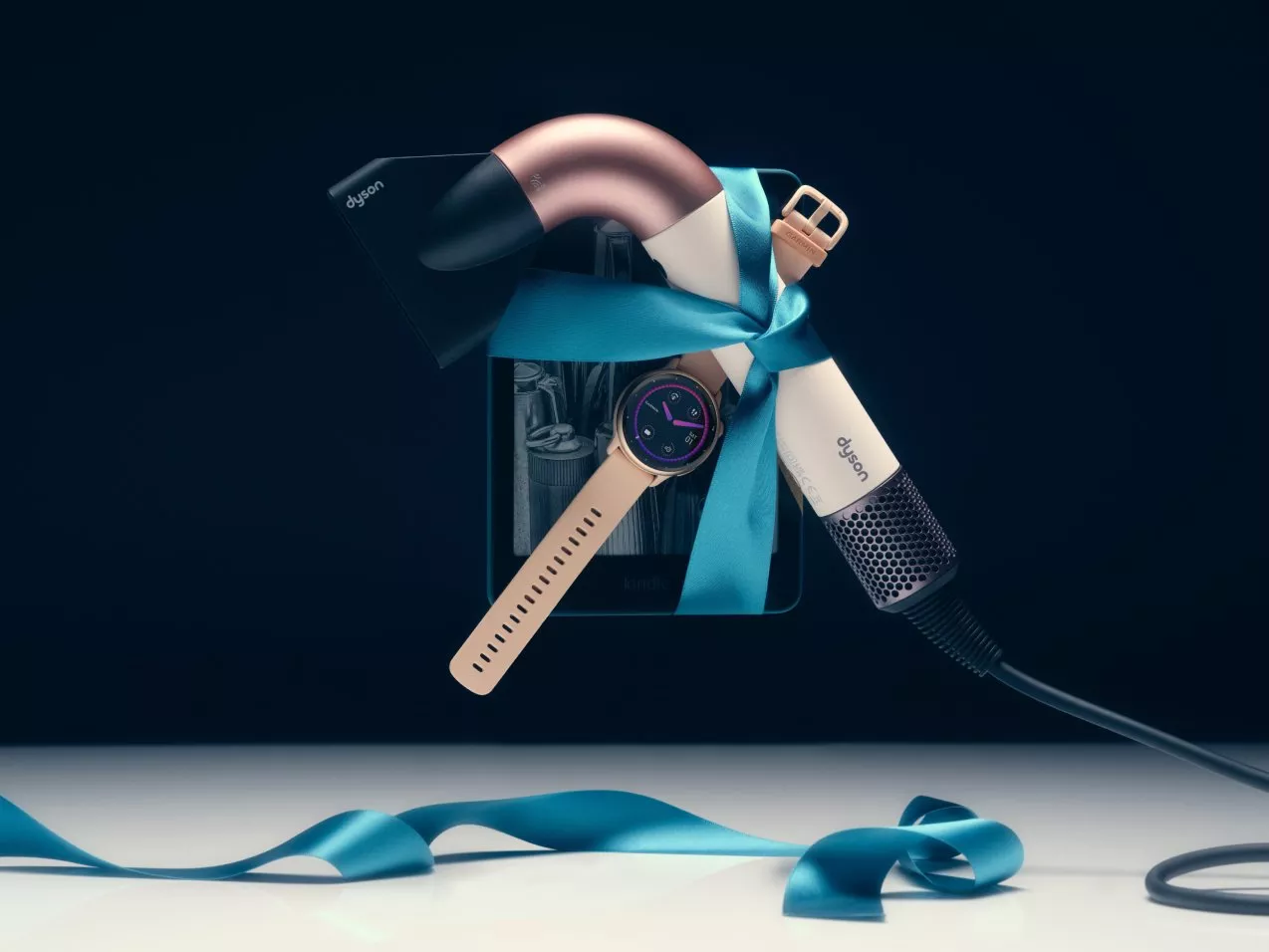 Image of a Dyson hairdryer, watch and kindle wrapped in a blue ribbon floating in mid-air