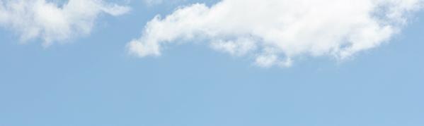 Blue sky background with soft white clouds, calm weather scene ideal for nature, travel or summer banners