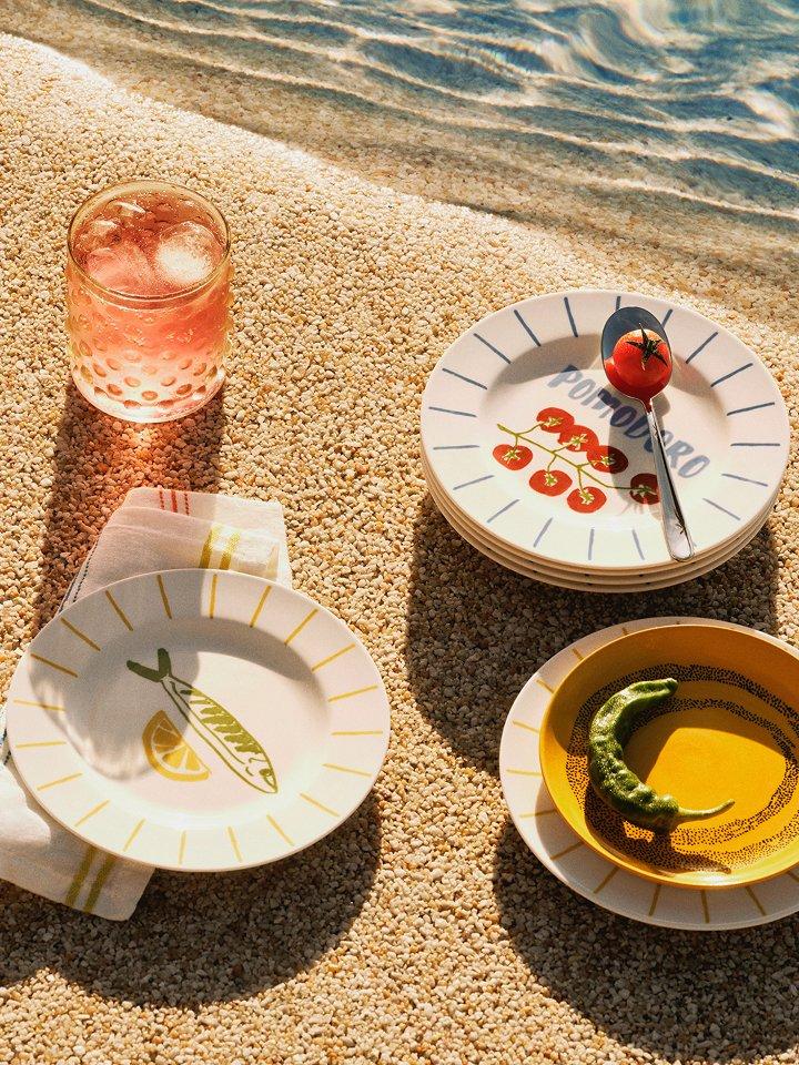 Outdoor diningware displayed on the beach