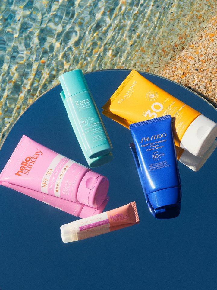 Travel-sized beauty products displayed on the beach
