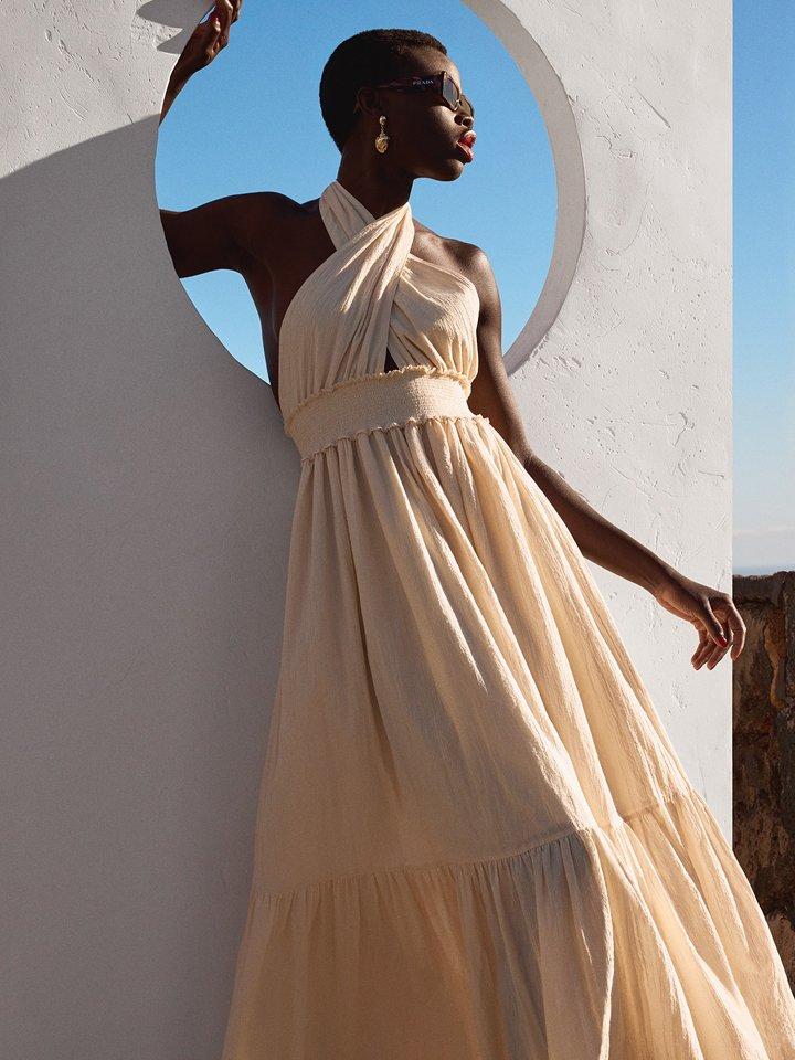 Female model posing in a long summer dress