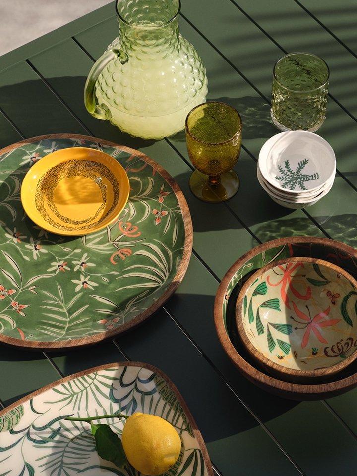 Various tableware items arranged on a green table