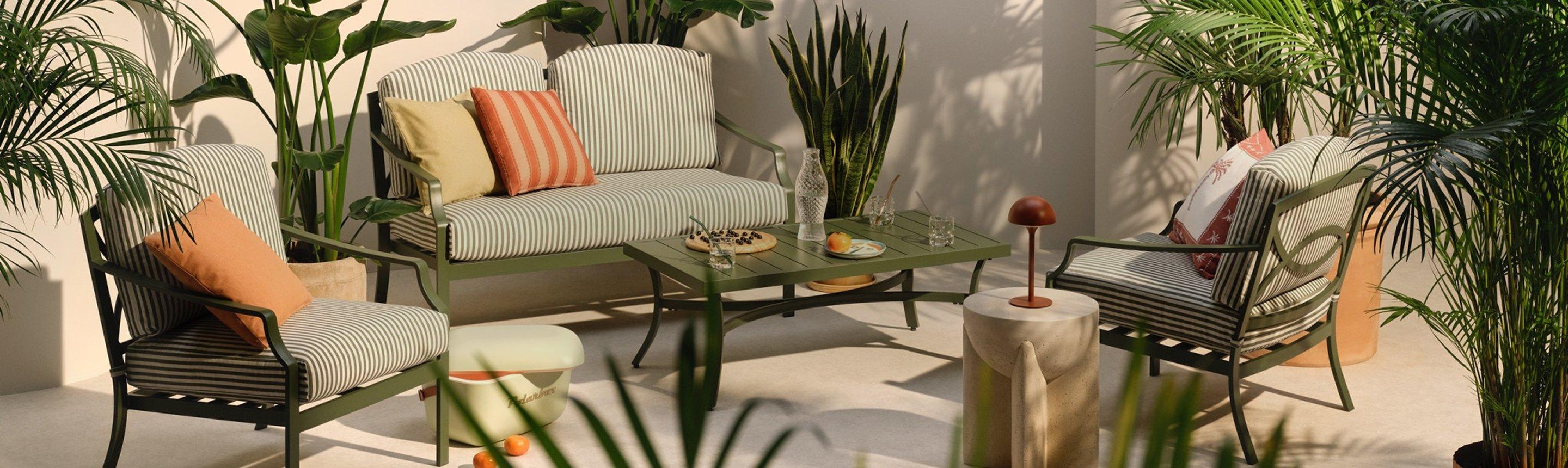 Selection of outdoor garden furniture displayed with plants