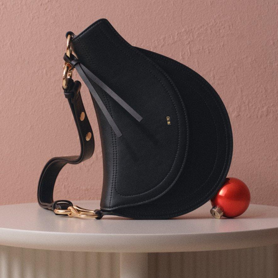 Women's black handbag on a table