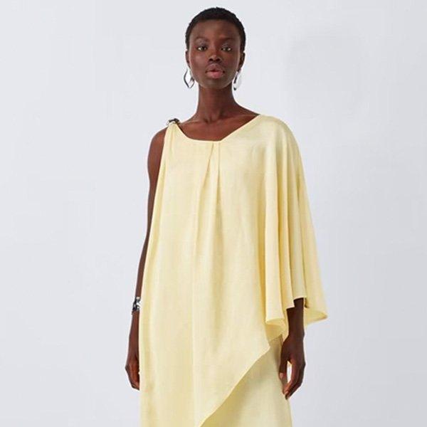 Light yellow asymmetric linen top on a dark-skinned model.