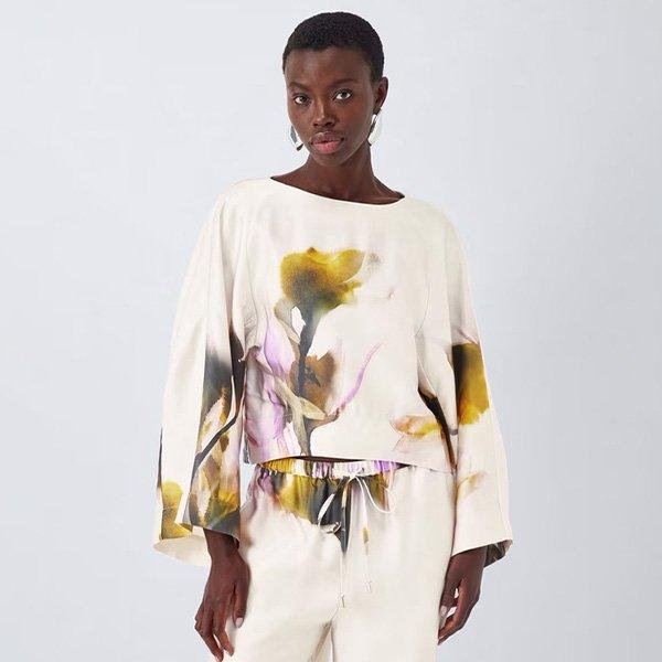 Woman in floral printed linen top.