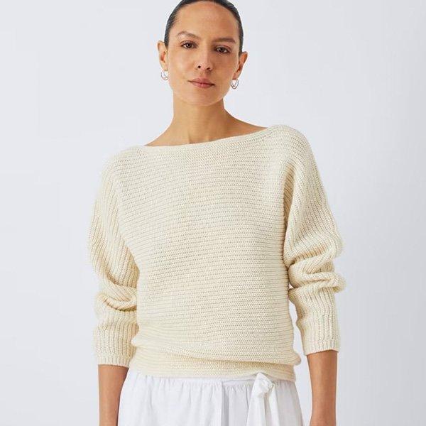 A womens wearing an ivory boat neck knit sweater