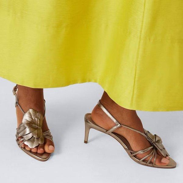 Metallic sandals with a leaf-like embellishment.