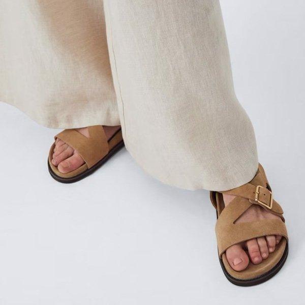 Light-colored pants and brown sandals.