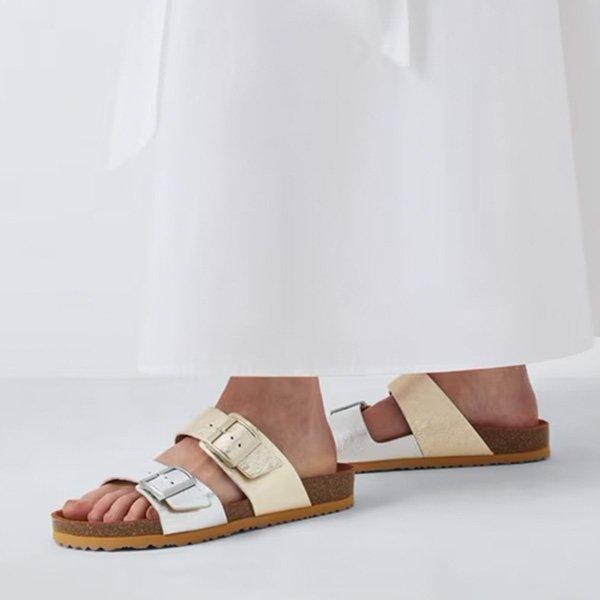 White pants and two-toned sandals.