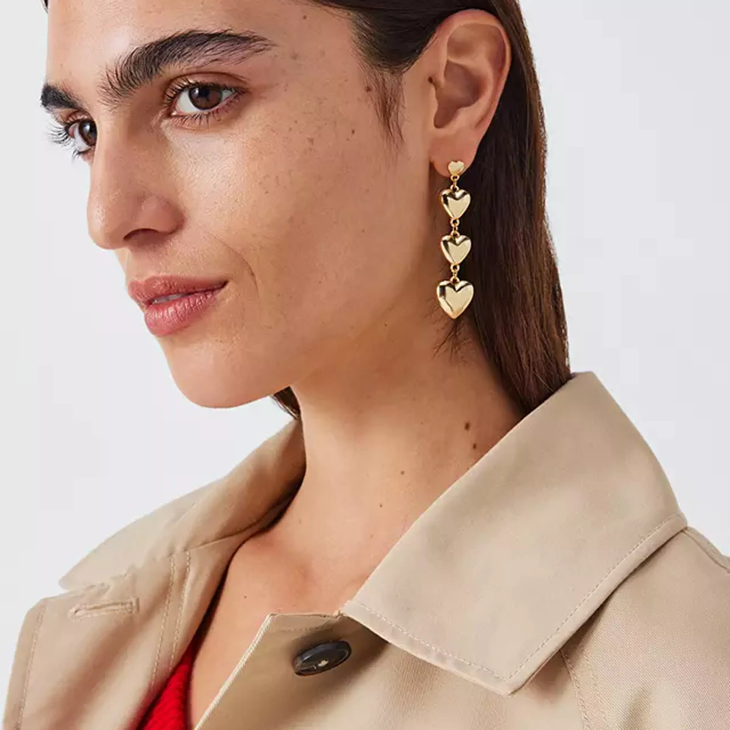 woman wearing pendant earrings