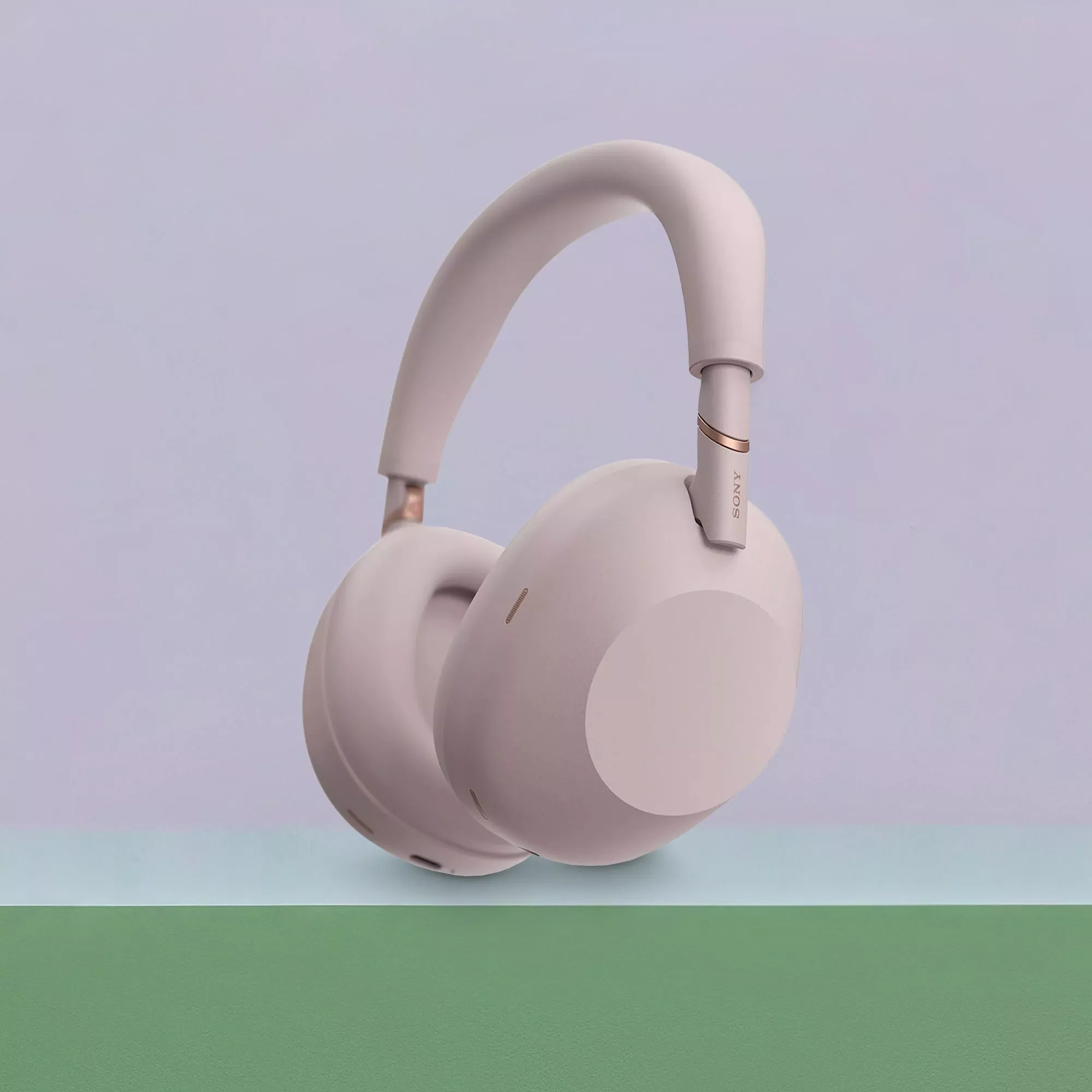 Sony over-ear wireless noise-cancelling headphones in light beige, close-up product photo on pastel background