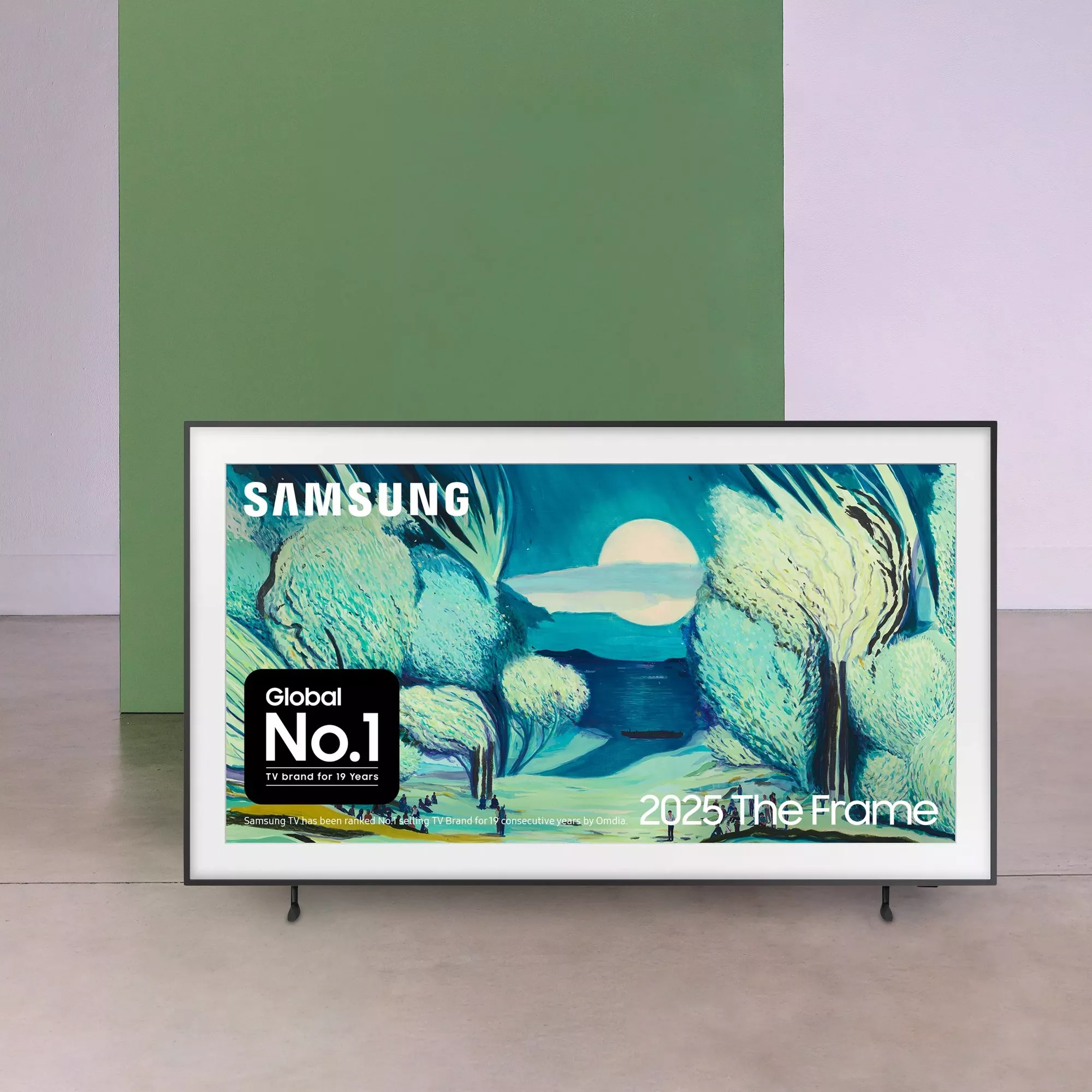 Samsung The Frame TV displaying colourful artwork, freestanding on floor against minimalist green wall backdrop