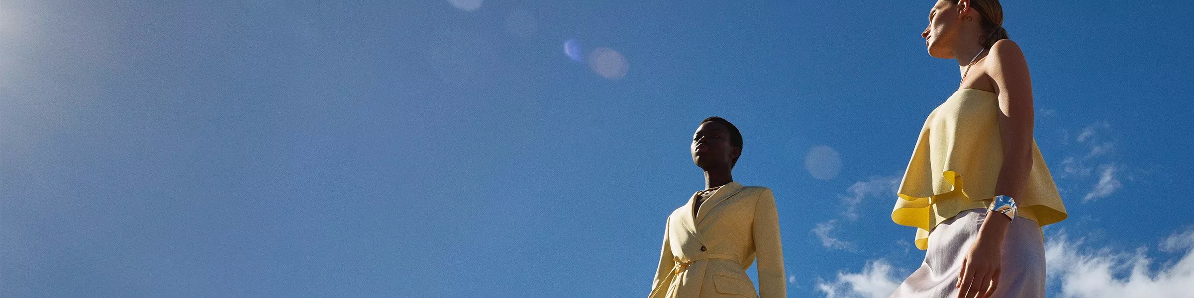 two women in yellow occasionwear pieces