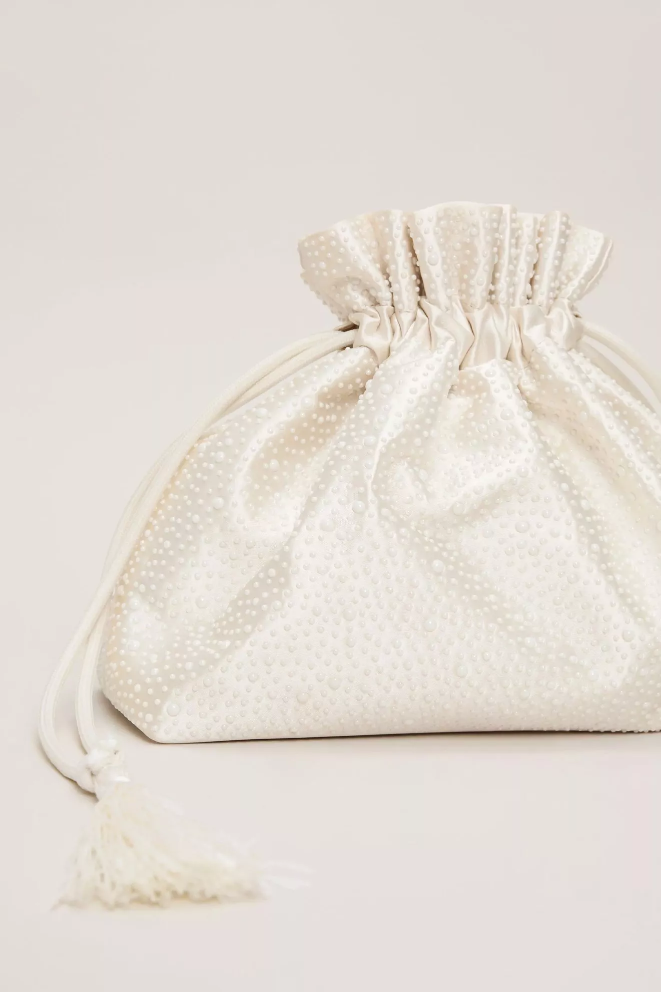 cream embellished clutch bag