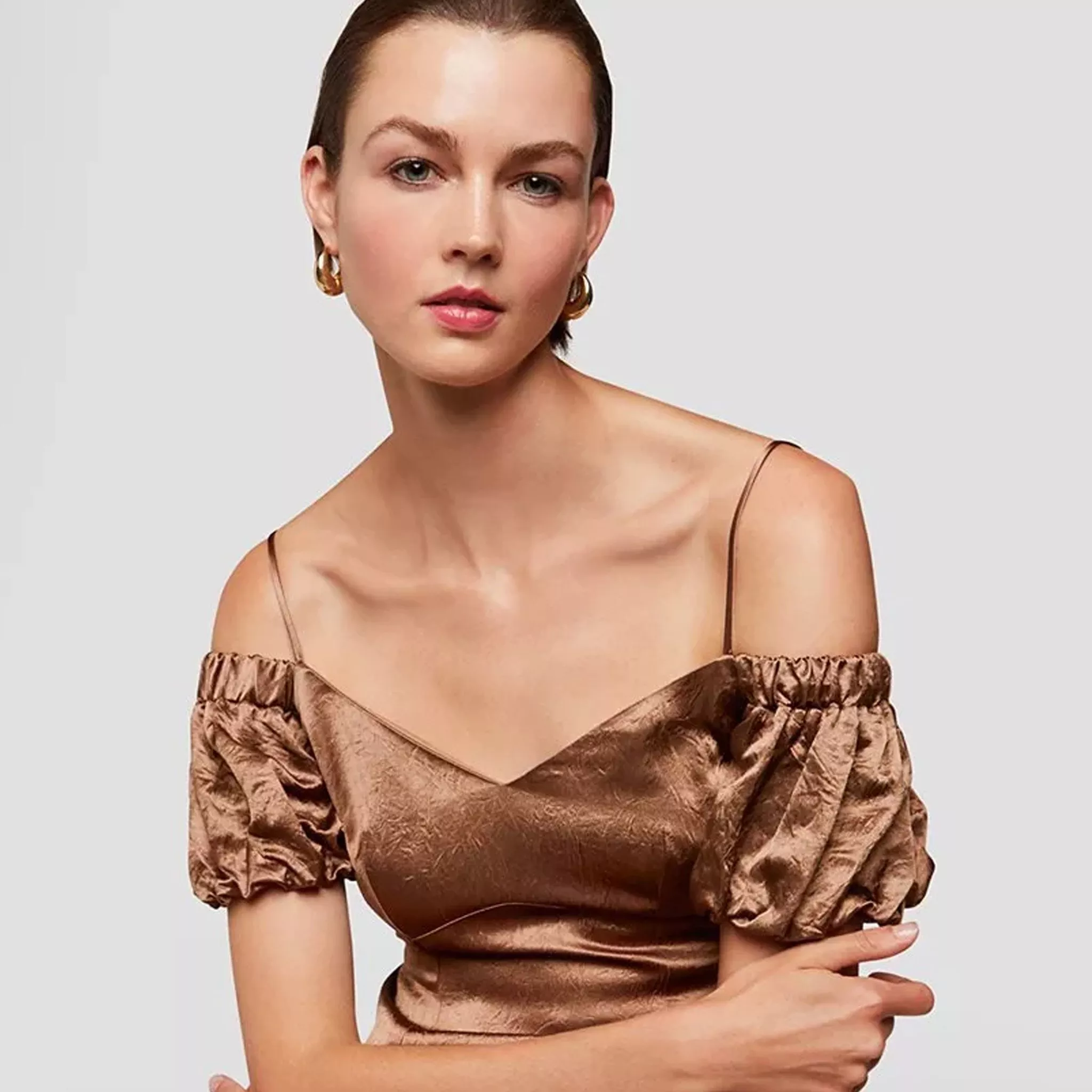 woman wearing bronze dress with sleeves